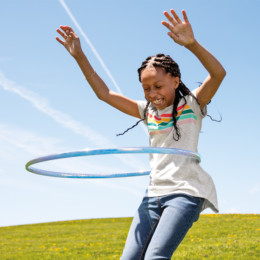 Young girl using a hula hoop