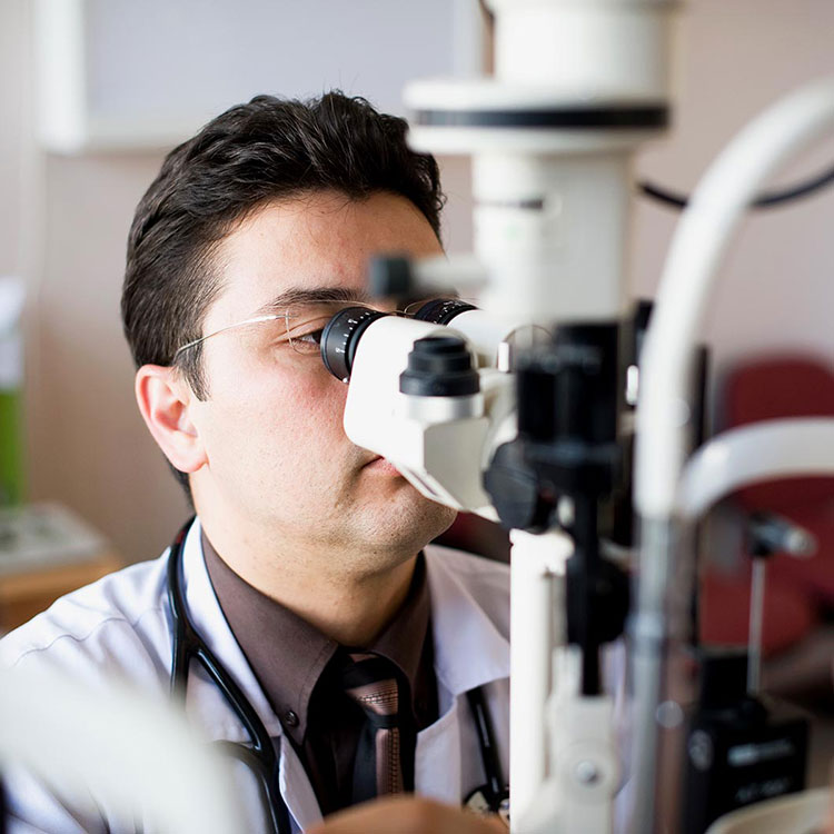 Male optometrist performing eye exam