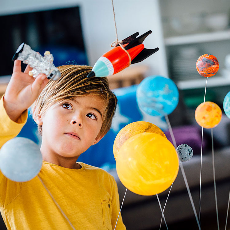 Boy playing with space toys