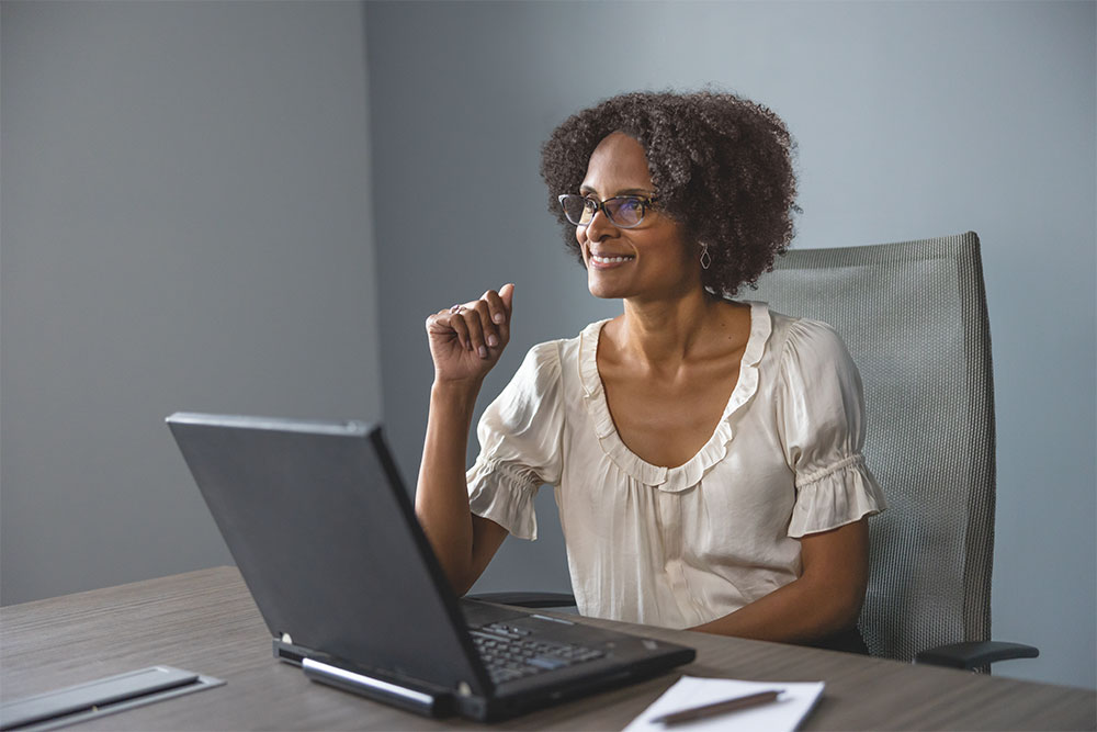 Woman with eyeglasses using a laptop