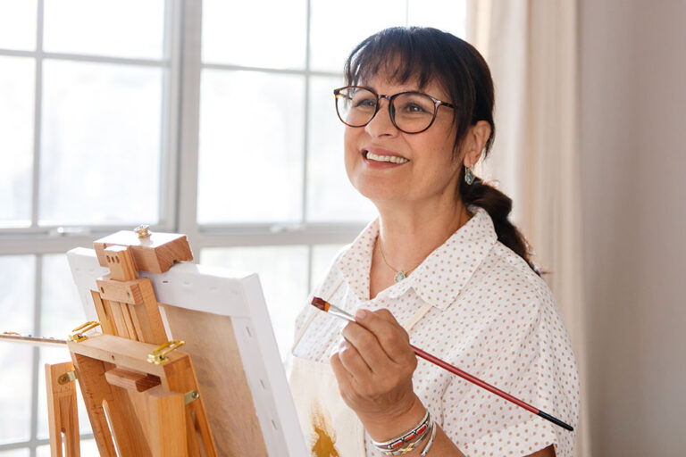 Woman wearing eyeglasses while painting