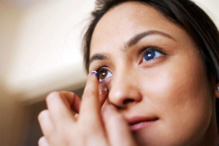 Person putting on a contact lens